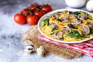 Spaghetti with mushrooms, cheese, spinach, rukkola and cherry tomatoes photo