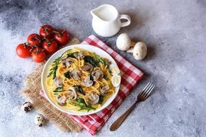 Spaghetti with mushrooms, cheese, spinach, rukkola and cherry tomatoes photo