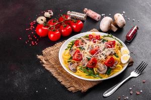 Spaghetti with mushrooms, cheese, spinach, rukkola and cherry tomatoes photo