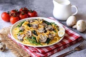 Spaghetti with mushrooms, cheese, spinach, rukkola and cherry tomatoes photo