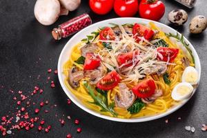 Spaghetti with mushrooms, cheese, spinach, rukkola and cherry tomatoes photo