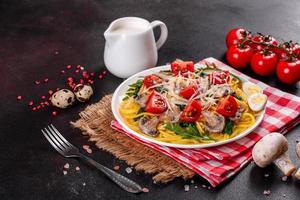 Spaghetti with mushrooms, cheese, spinach, rukkola and cherry tomatoes photo