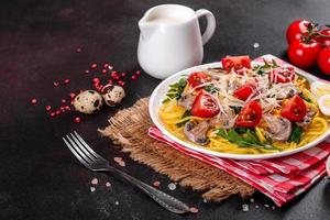 Spaghetti with mushrooms, cheese, spinach, rukkola and cherry tomatoes photo