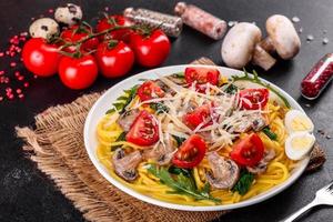 Spaghetti with mushrooms, cheese, spinach, rukkola and cherry tomatoes photo