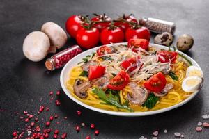 Spaghetti with mushrooms, cheese, spinach, rukkola and cherry tomatoes photo