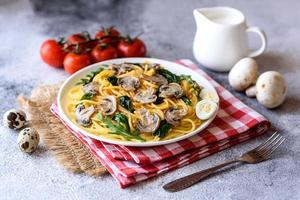 Spaghetti with mushrooms, cheese, spinach, rukkola and cherry tomatoes photo