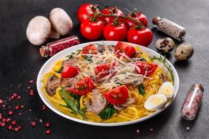 Spaghetti with mushrooms, cheese, spinach, rukkola and cherry tomatoes photo