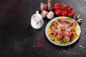 Spaghetti with mushrooms, cheese, spinach, rukkola and cherry tomatoes photo