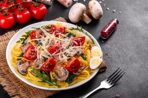 Spaghetti with mushrooms, cheese, spinach, rukkola and cherry tomatoes photo
