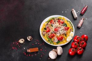 Spaghetti with mushrooms, cheese, spinach, rukkola and cherry tomatoes photo