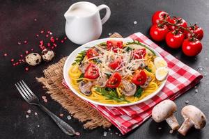 Spaghetti with mushrooms, cheese, spinach, rukkola and cherry tomatoes photo