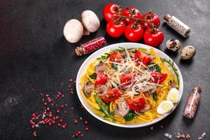 Spaghetti with mushrooms, cheese, spinach, rukkola and cherry tomatoes photo