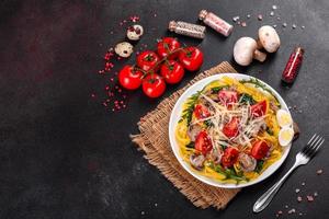 Spaghetti with mushrooms, cheese, spinach, rukkola and cherry tomatoes photo