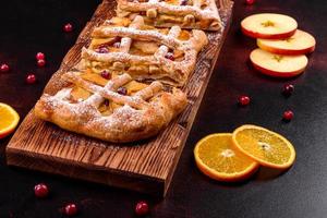 Delicious fresh pie baked with apple, pears and berries photo