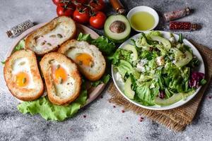 Delicious breakfast with grunts, eggs, avocado and cherry tomatoes photo
