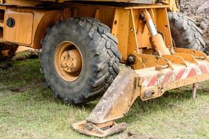 The modern excavator performs excavation work on the construction site photo