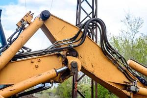The modern excavator performs excavation work on the construction site photo