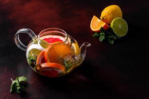 Hot fruit tea with lemon, mint, orange, lime and grapefruit photo