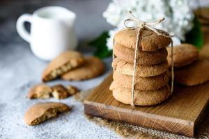 Homemade oatmeal cookies on a wooden cutting board photo