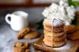 Homemade oatmeal cookies on a wooden cutting board photo