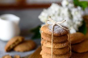 Homemade oatmeal cookies on a wooden cutting board photo