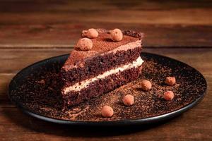 A piece of delicious chocolate cake with berries photo