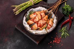 Roll with bacon and chicken mince on a stew with fresh asparagus photo