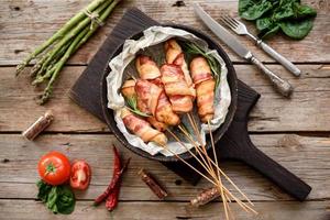 Roll with bacon and chicken mince on a stew with fresh asparagus photo