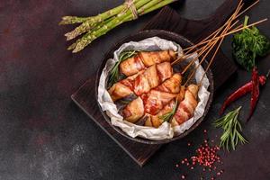 Roll with bacon and chicken mince on a stew with fresh asparagus photo