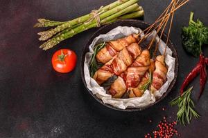 Roll with bacon and chicken mince on a stew with fresh asparagus photo