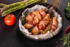 Roll with bacon and chicken mince on a stew with fresh asparagus photo