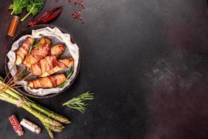 Roll with bacon and chicken mince on a stew with fresh asparagus photo