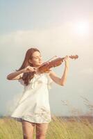 Beautiful women enjoy playing violin photo