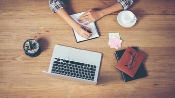 Top view of hipster woman hands writing on notebook. photo