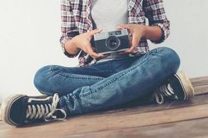 Young beautiful hipster woman with an old retro camera. photo