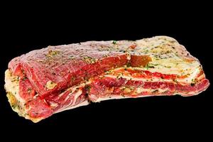 Raw beef ribs marinated isolate on black background. photo