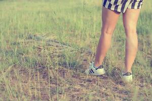 Woman enjoying life standing in a grass field photo