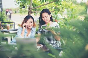 Two young beautiful women chatting and enjoying happy time together photo