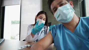 paziente che scatta un selfie con mentre un medico sta vaccinando video