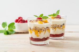 Homemade fresh mango and fresh raspberry with yogurt and granola - healthy food style photo