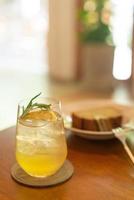 Iced lemon honey glass with rosemary in cafe restaurant photo