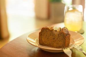 Banana cake on plate in cafe restaurant - soft selective focus point photo