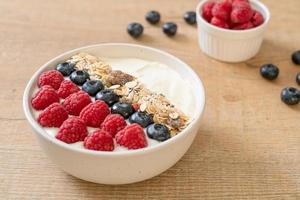 Homemade yogurt bowl with raspberry, blueberry, and granola  - healthy food style photo