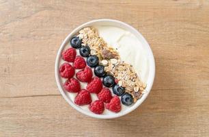 Homemade yogurt bowl with raspberry, blueberry, and granola  - healthy food style photo