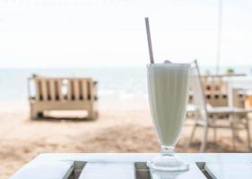 Vanilla milkshake smoothie in cafe photo