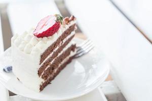 Vanilla and chocolate cake with strawberry in cafe photo