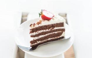 Vanilla and chocolate cake with strawberry in cafe photo