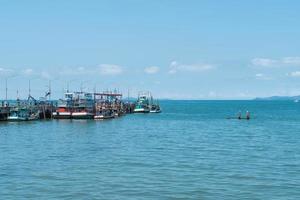 Fishing boat port with sea background photo