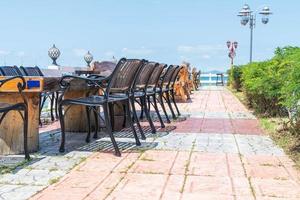 Silla y mesa en el restaurante con terraza con fondo de vista al mar foto