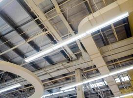 Ceiling mounted Lamps pipes and air ducts and communication system photo